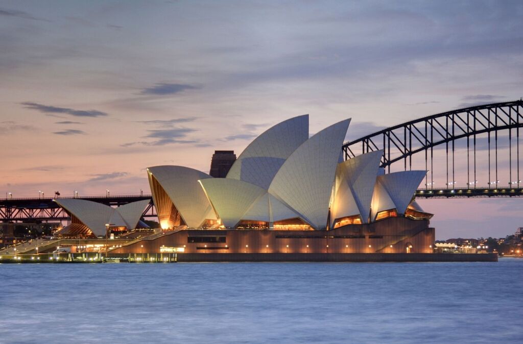 Sydney Opera House at sunset with Sydney Harbour Bridge in background