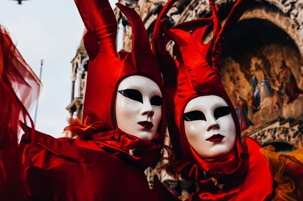 A masked and costumed couple attend Carnevale di Venezia in Venice, Italy